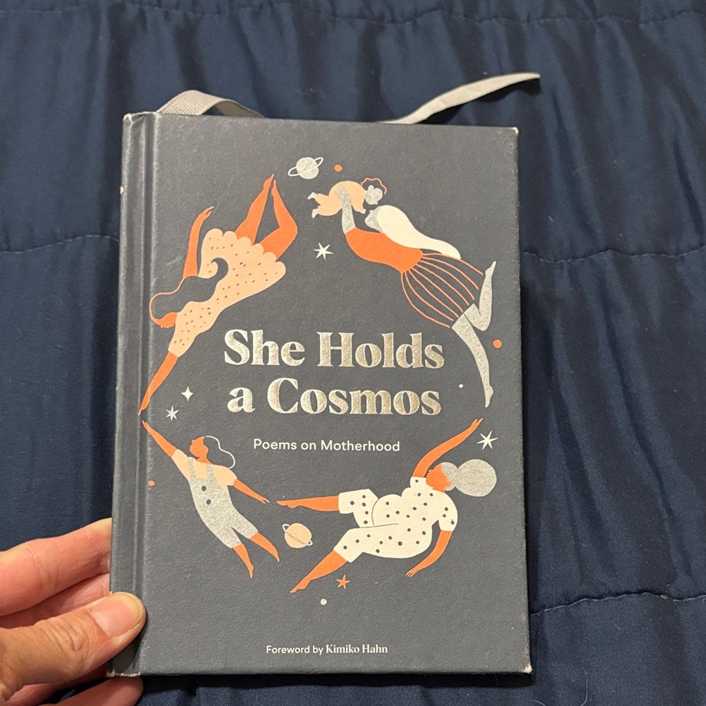 She Holds a Cosmos Poetry Book